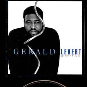 May include: CD album cover featuring Gerald Levert. The album title is "groove On." The cover has a black and white photo of Gerald Levert with the album title and artist's name in blue and white text. The CD itself is black with white text.