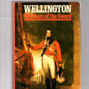 May include: A book cover featuring a portrait of a man in a red military uniform holding a sword. The title of the book is "Wellington: The Years of the Sword" and the author is "Elizabeth Longford".