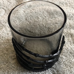Glass with skeleton hand