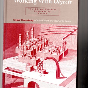 May include: Book cover with a red and white illustration of a complex machine with gears and levers. The title of the book is "Working With Objects" and the subtitle is "The OOram Software Engineering Method". The author is Trygve Reenskaug with Per Wold and Odd Arild Lehne. The text "...by the creator of the Model-View-Controller concept..." is at the bottom of the cover.