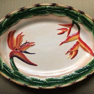 Ceramic oval platter with Bird of Paradise flowers and rattan edge in relief