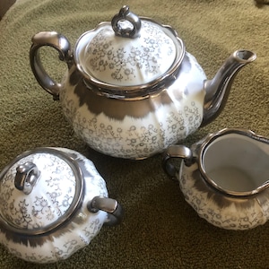 Sterling China silver - teapot, sugar bowl and creamer