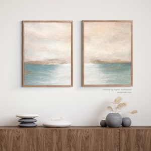 Abstract coastal sunset, set of 2 art prints. Soft pastel painting blush pink turquoise teal modern contemporary 2 panel art, framed with wooden Fram, hanging on the wall.