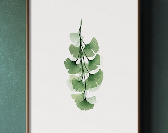 May include: A framed watercolor print of a green ginkgo leaf branch hangs on a dark green wall. A small table with a vase of dried branches and a wicker basket with a dried plant are in the foreground.