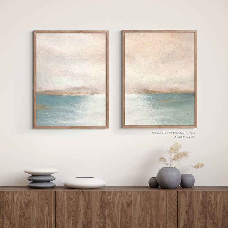 Abstract coastal sunset, set of 2 art prints. Soft pastel painting blush pink turquoise teal modern contemporary 2 panel art, framed with wooden Fram, hanging on the wall.