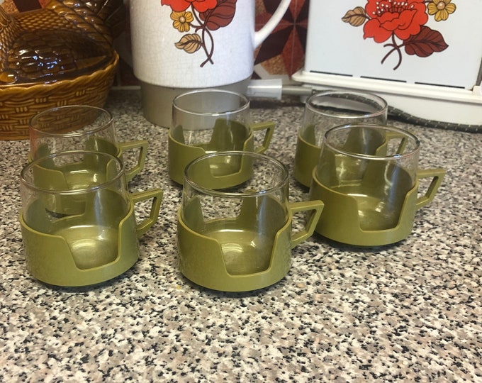 JAJ pyrex cups in green coloured plastic holders set of 6 coffee cups