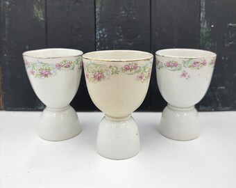 Set of 3 Ironstone double egg cups, Homer Laughlin The Angelus, crazed and stained creamy white with pink flowers