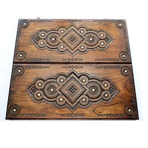 May include: A wooden backgammon board with intricate carvings and inlaid details. The board is closed and features a dark brown finish.