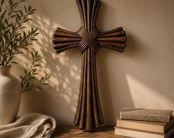 May include: A wall-mounted cross constructed from multiple dark brown, rounded wooden rods bundled together. The rods are arranged in a vertical and horizontal orientation, meeting at a central point where they are wrapped with additional wood strips.