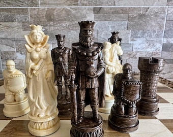 May include: A full chess set with detailed carvings in ivory and dark brown. The king is central, with other pieces such as the queen, knight, and rook. The set is arranged on a chequered board. The pieces are made of wood.