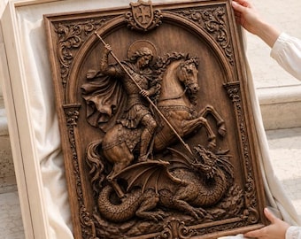 May include: A rectangular wooden wall plaque featuring a detailed relief carving of a knight on horseback wielding a spear against a dragon. The artwork is framed by an ornate border with a shield emblem at the top, finished in a dark brown tone.