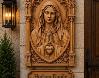 May include: A rectangular wooden wall plaque featuring a relief carving of a figure with a veil and hands in prayer, positioned above a smaller hanging wooden sign with the text "Hudson Family" engraved in a dark, serif font.