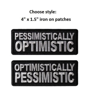 May include: Two iron-on patches, each 4 inches by 1.5 inches. The top patch is black with white text that reads "PESSIMISTICALLY OPTIMISTIC". The bottom patch is black with white text that reads "OPTIMISTICALLY PESSIMISTIC".