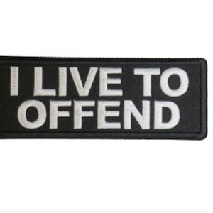 May include: Black and white embroidered patch with the text "I LIVE TO OFFEND" in white lettering.