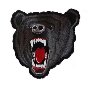 May include: Black embroidered patch of a bear's head with a ferocious expression, showing sharp teeth and an open mouth with a red tongue.