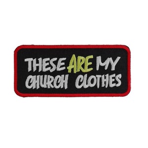 May include: Black embroidered patch with red stitching. The patch says "These are my church clothes" in white and yellow lettering.