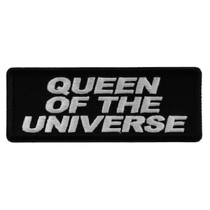 May include: Black embroidered patch with white text that reads "QUEEN OF THE UNIVERSE".