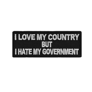 May include: Black and white embroidered patch with the text "I love my country but I hate my government".