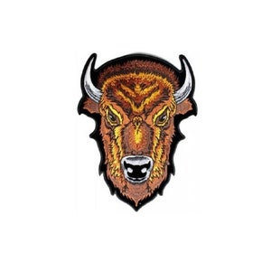 May include: Embroidered patch of a brown bison head with black outlines and white horns. The bison has a fierce expression with a black nose and mouth.