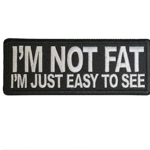 May include: Black embroidered patch with white text that reads "I'm not fat I'm just easy to see."