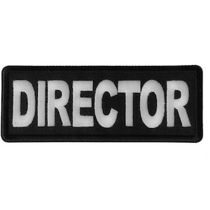 May include: Black fabric patch with white embroidered text that reads "DIRECTOR".