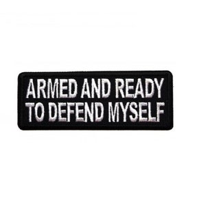 May include: Black and white embroidered patch with the text "Armed and Ready to Defend Myself".