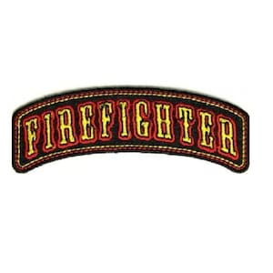 May include: A black, arched patch with the word "FIREFIGHTER" in bold, yellow letters outlined in red. The patch has a red border with yellow stitching, and is set against a white background.