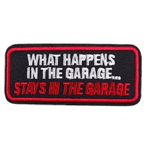 May include: Black and red embroidered patch with the text "What happens in the garage... stays in the garage."