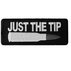 May include: Black embroidered patch with white text that reads "JUST THE TIP" and a white bullet underneath.