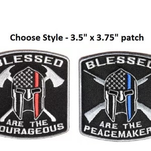 May include: Two embroidered patches, each 3.5 inches by 3.75 inches, featuring a Spartan helmet with crossed axes and an American flag. The first patch has a red stripe down the flag and the text "Blessed Are The Courageous". The second patch has a blue stripe down the flag and the text "Blessed Are The Peacemakers".