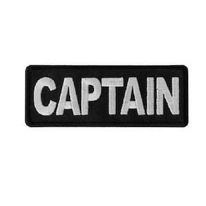 May include: Black embroidered patch with white lettering that reads "CAPTAIN".