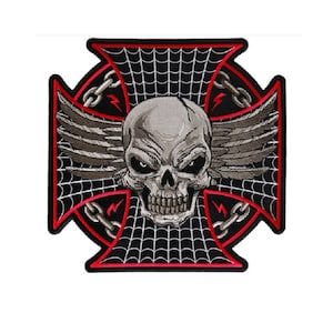 May include: A black and red embroidered patch with a skull with wings in the center. The skull is surrounded by a spider web design with chains on the sides.