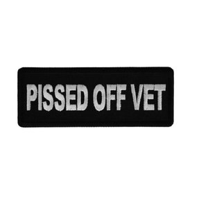 May include: Black rectangular patch with white embroidered text that reads "PISSED OFF VET".