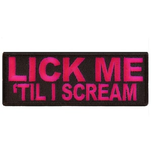 May include: Black patch with pink lettering that reads "LICK ME 'TIL I SCREAM".