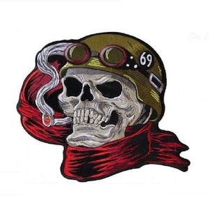 May include: Embroidered patch featuring a skull wearing a military-style helmet with goggles and the number "69". The skull is smoking a cigarette and wearing a red scarf. The patch is likely for jackets or bags.