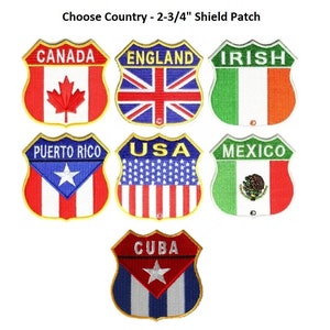 May include: Set of 2-3/4 inch iron-on patches featuring various country flags in a shield shape. The flags include Canada, England, Ireland, Puerto Rico, USA, Mexico, and Cuba.