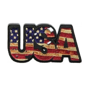 May include: A red, white, and blue embroidered patch with the word "USA" in a bold font. The letters are filled with the American flag design.