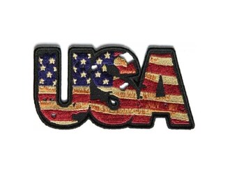 May include: A red, white, and blue embroidered patch with the word "USA" in a bold font. The letters are filled with the American flag design.