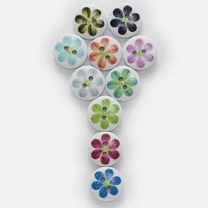 May include: A collection of ten round, white buttons arranged in a vertical pattern. Each button features a two-hole center and a printed flower design in various colors, including green, black, light blue, orange, purple, gray, and dark pink.