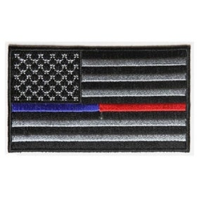 May include: Black and white American flag patch with a thin blue line and a thin red line. The patch is embroidered and has a black border.