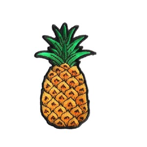 May include: An embroidered iron-on patch shaped like a pineapple. The fruit body features a golden-yellow diamond pattern with dark orange shading, while the spiky leaves at the top are a vibrant green. The entire design is outlined in black thread.