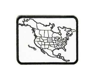 May include: Black and white embroidered patch of a map of North America, showing the United States with state borders.