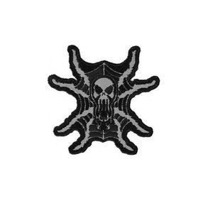May include: Black and gray embroidered patch of a skull with a spider web design.