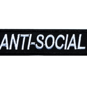 May include: Black embroidered patch with white text that reads "ANTI-SOCIAL".