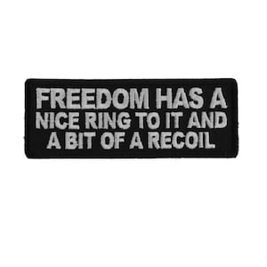 May include: Black embroidered patch with white text that reads "Freedom has a nice ring to it and a bit of a recoil."