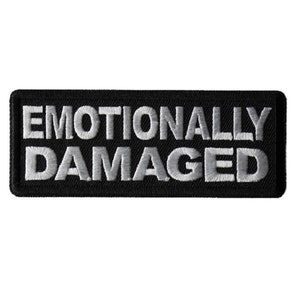 May include: Black embroidered patch with white text that reads "Emotionally Damaged".