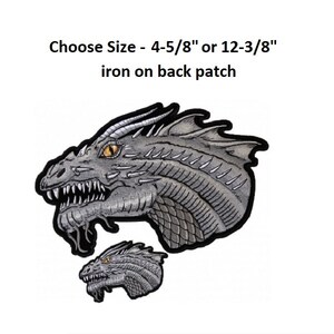 May include: Two iron-on patches of a gray dragon head with yellow eyes. The larger patch is 4-5/8 inches and the smaller patch is 12-3/8 inches. Choose Size - 4-5/8" or 12-3/8" iron on back patch.