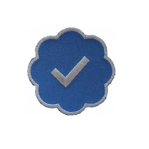 May include: A blue embroidered patch with a white checkmark in the center. The patch is shaped like a cloud with a white outline.
