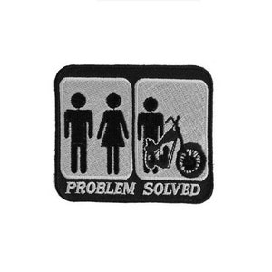 May include: Black and white embroidered patch with two stick figures representing a man and woman, and a motorcycle. The text "PROBLEM SOLVED" is below the figures.