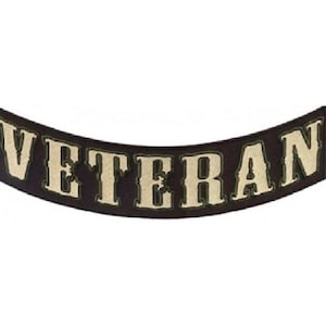 May include: Black and white curved patch with the word "Veteran" in white lettering.